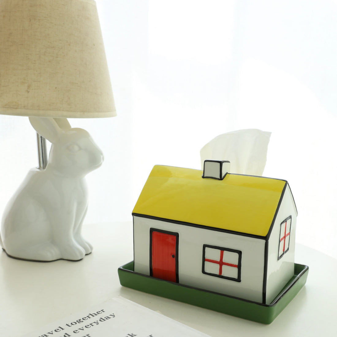 House-shaped tissue box cover with a red door and yellow roof on a white background