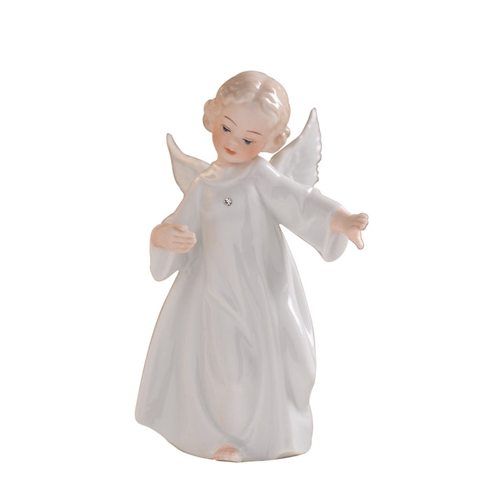 Glossy white porcelain angel figurine in a flowing robe with one arm outstretched and one bent to chest on white.