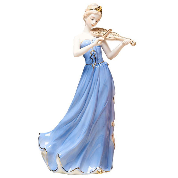 Full studio view of a porcelain figurine of a female violinist in a long blue gown playing violin against a white backdrop.