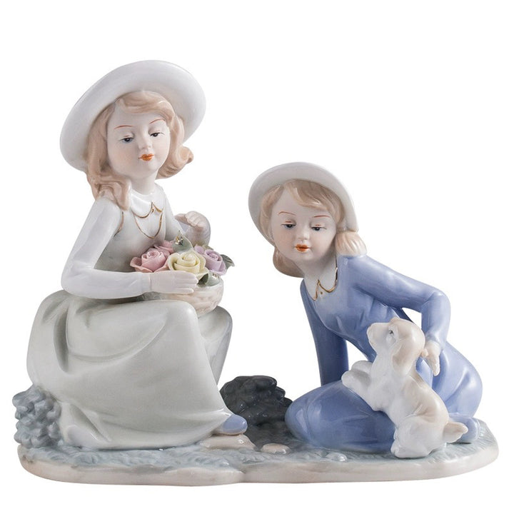 Porcelain figurine of a woman holding a rose basket and a kneeling girl in a blue dress with a white puppy.