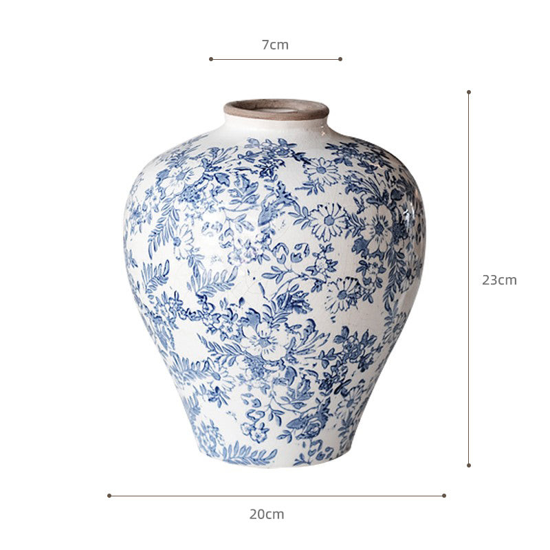 White ceramic vase with blue floral pattern, measuring 23cm tall and 20cm wide