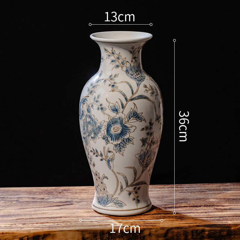Ceramic vase with floral patterns on a wooden surface, shown with measurements.