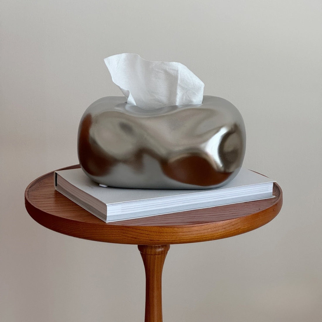 Silver tissue box cover on a wooden side table with a plain background #color_silver