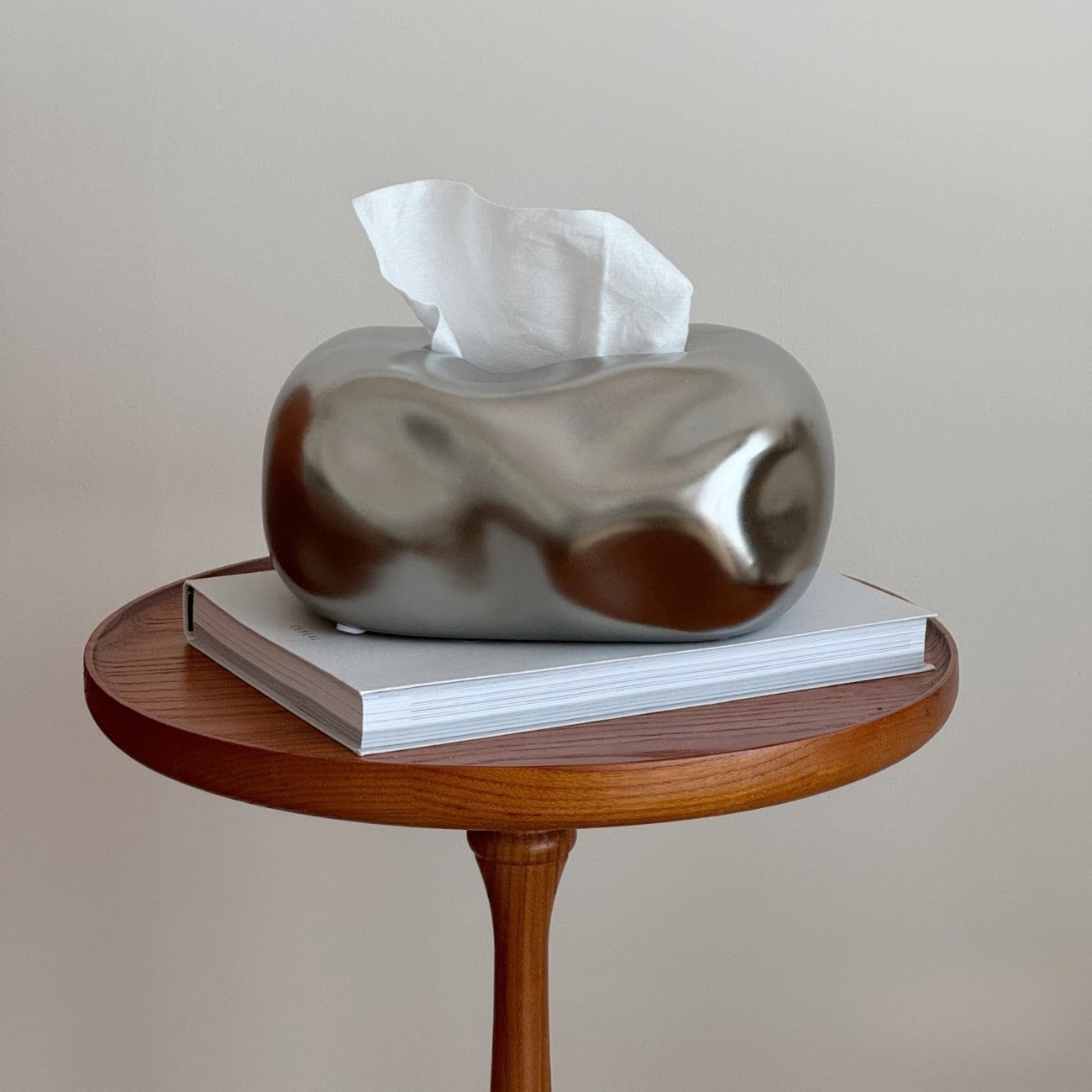 Silver tissue box cover on a wooden side table with a plain background #color_silver