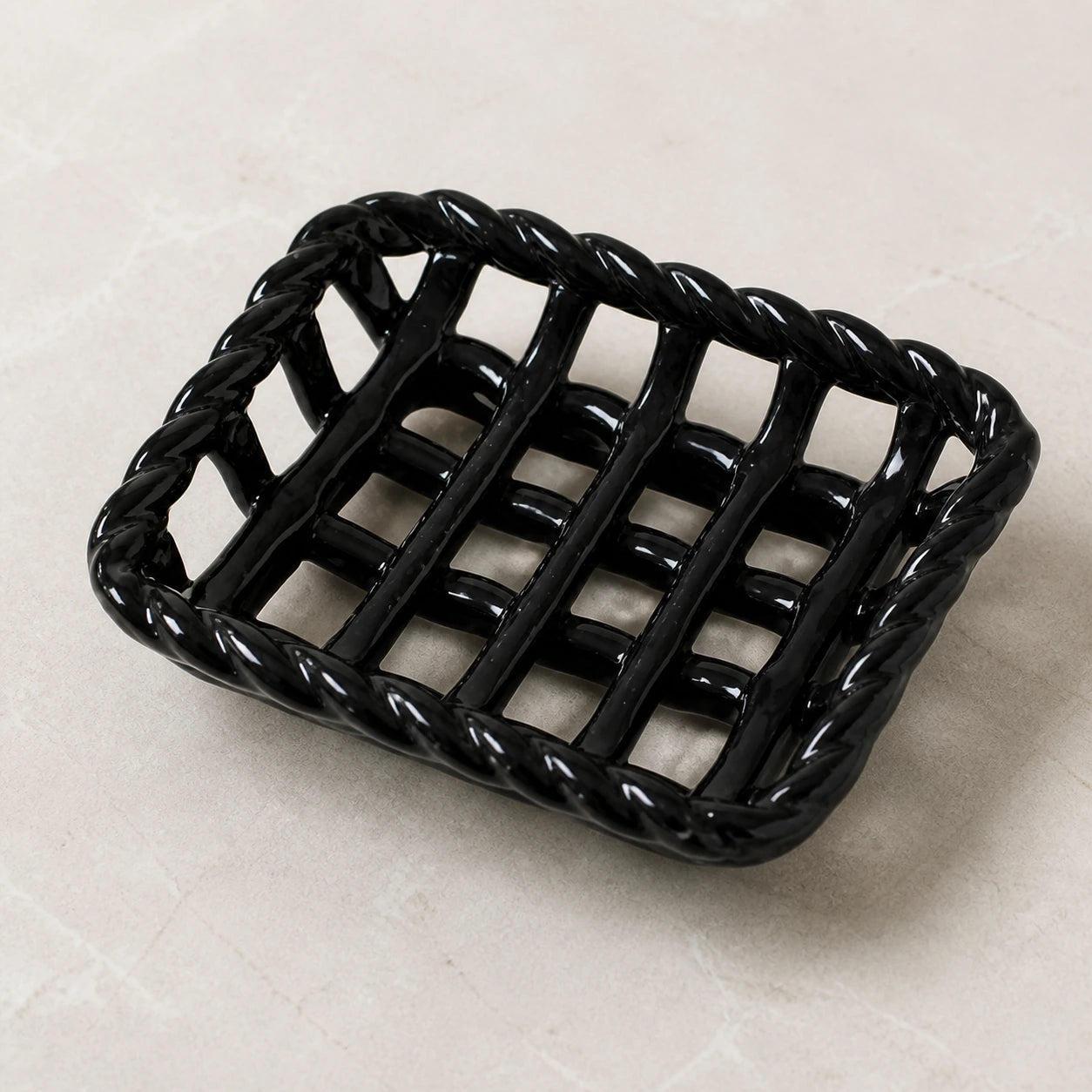 Close view of the glossy black braided rim and open ceramic lattice
