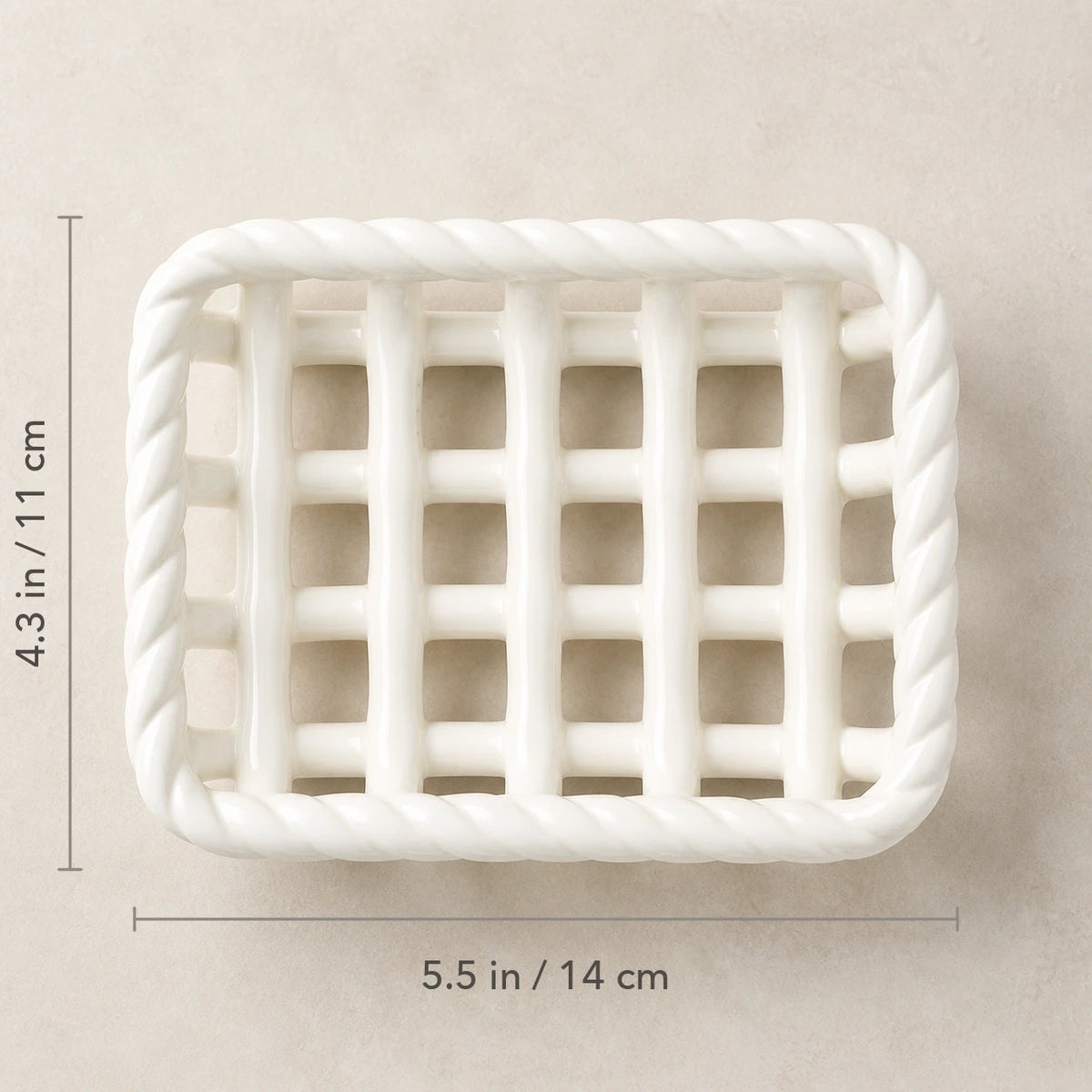 Top view of the Glossy White soap basket marked 5.5 by 4.3 inches
