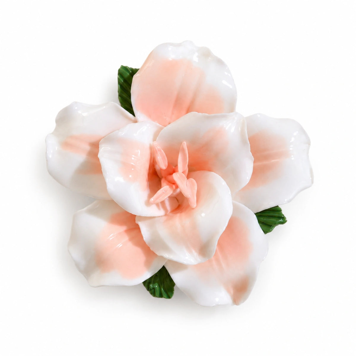 Soft Orange ceramic lily fridge magnet with green leaves on a white background.