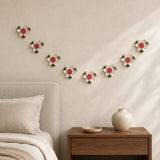 Multiple 7 cm Small Lotus Bloom ceramic wall flowers with rose red accent arranged as a wall grouping in a warm neutral interior.