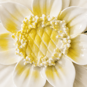 Close frontal view of the golden yellow center and layered glazed petals of the Large Lotus Bloom ceramic wall flower.