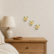 7 cm Small Ruffled Peony ceramic wall flower with golden yellow accent styled in a warm neutral interior.