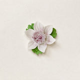 Front view of the Small Lotus Bloom ceramic wall flower with plum purple accent.
