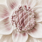 Close frontal view of the plum purple center and layered glazed petals of the Large Lotus Bloom ceramic wall flower.