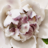 Close frontal view of the plum purple center and layered glazed petals of the Small Ruffled Peony ceramic wall flower.