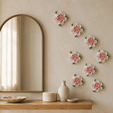 Multiple 9 cm Medium Ruffled Peony ceramic wall flowers with rose red accent arranged as a wall grouping in a warm neutral interior.