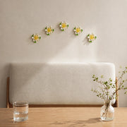 9 cm Medium Lotus Bloom ceramic wall flower with golden yellow accent styled in a warm neutral interior.