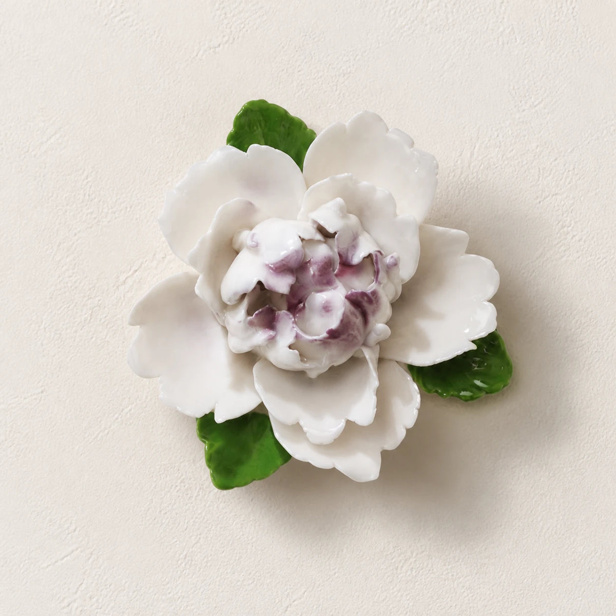 Front view of the Small Ruffled Peony ceramic wall flower with plum purple accent.
