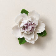 Front view of the Small Ruffled Peony ceramic wall flower with plum purple accent.