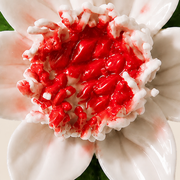 Close frontal view of the rose red center and layered glazed petals of the Small Lotus Bloom ceramic wall flower.