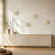 Multiple 15 cm Extra Large Ruffled Peony ceramic wall flowers with golden yellow accent arranged as a wall grouping in a warm neutral interior.