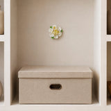 9 cm Medium Ruffled Peony ceramic wall flower with golden yellow accent styled in a warm neutral interior.
