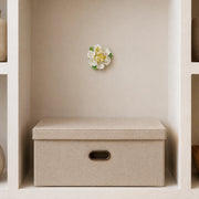 9 cm Medium Ruffled Peony ceramic wall flower with golden yellow accent styled in a warm neutral interior.