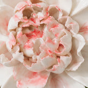 Close frontal view of the rose red center and layered glazed petals of the Extra Large Ruffled Peony ceramic wall flower.
