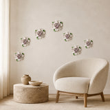 Multiple 9 cm Medium Ruffled Peony ceramic wall flowers with plum purple accent arranged as a wall grouping in a warm neutral interior.