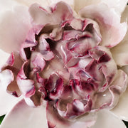Close frontal view of the plum purple center and layered glazed petals of the Extra Large Ruffled Peony ceramic wall flower.