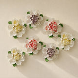 Medium Ruffled Peony ceramic wall flowers with golden yellow, plum purple and rose red accents arranged together on a warm neutral wall.
