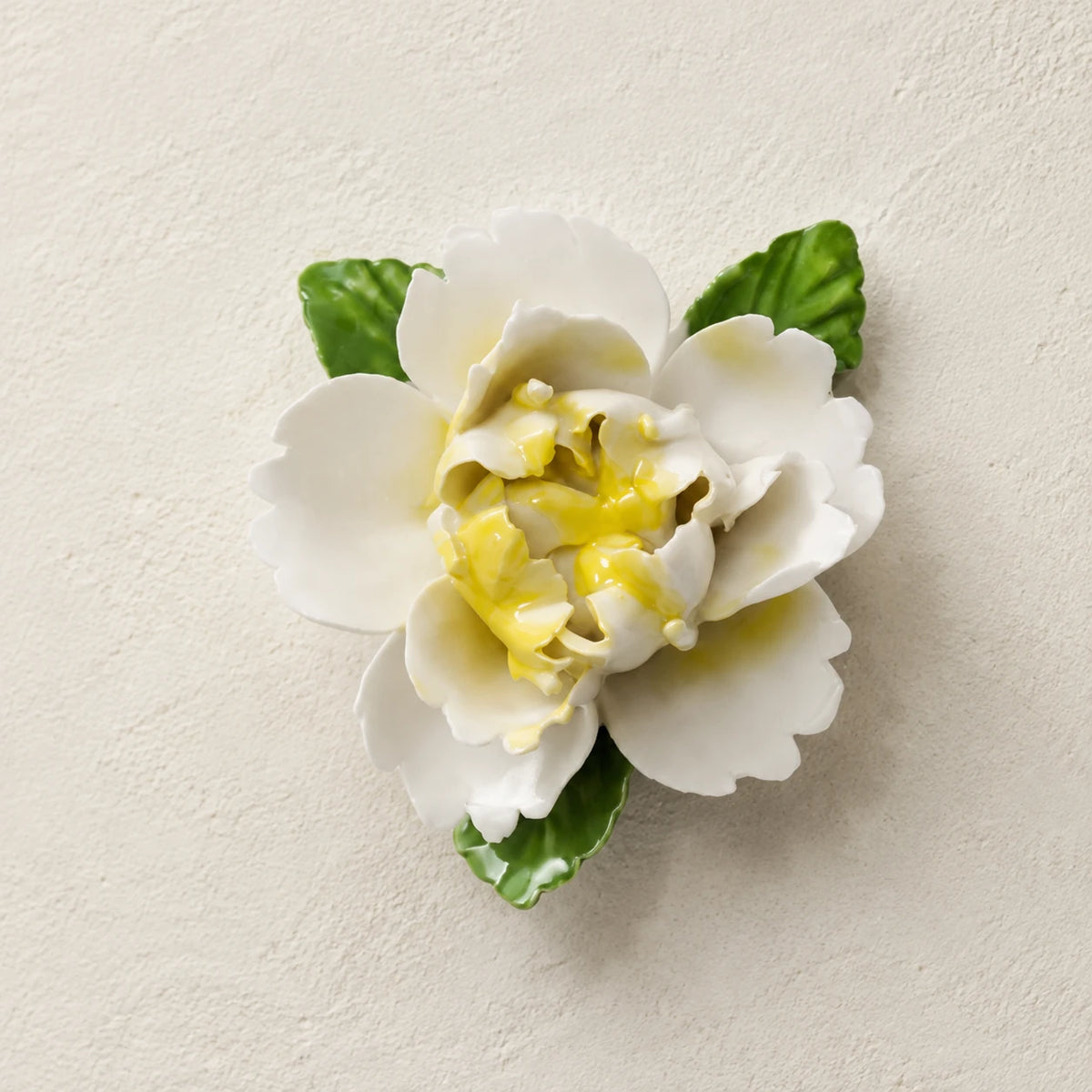 Front view of the Small Ruffled Peony ceramic wall flower with golden yellow accent.