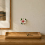 9 cm Medium Lotus Bloom ceramic wall flower with rose red accent styled in a warm neutral interior.