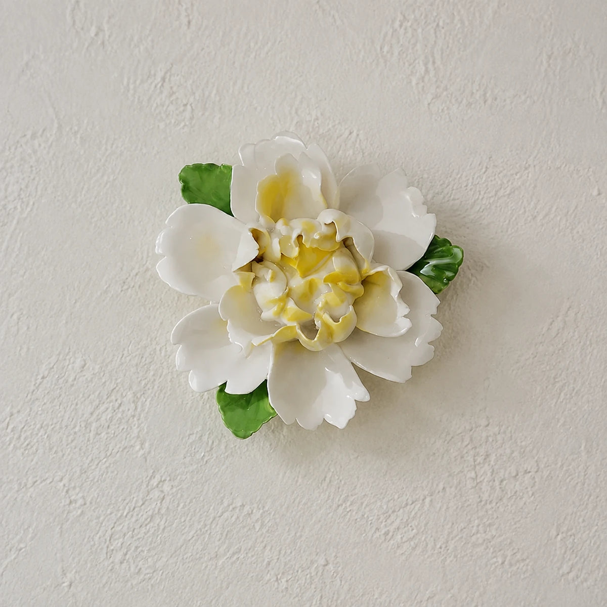 Front view of the Medium Ruffled Peony ceramic wall flower with golden yellow accent.