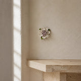 9 cm Medium Ruffled Peony ceramic wall flower with plum purple accent styled in a warm neutral interior.