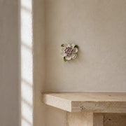 9 cm Medium Ruffled Peony ceramic wall flower with plum purple accent styled in a warm neutral interior.