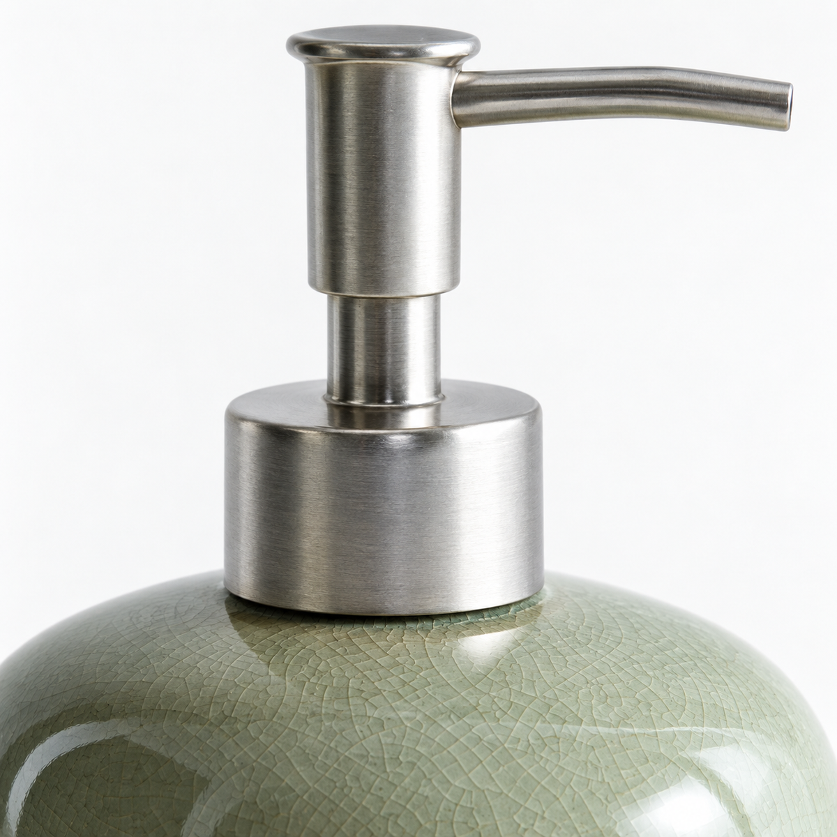 Macro view of the silver-tone pump, collar and sage-green crackle-glazed ceramic shoulder of the Willow Sage soap dispenser.