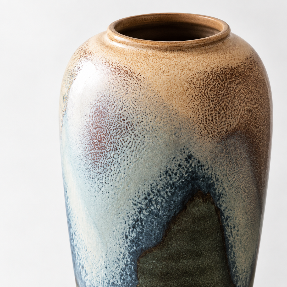 Tall blue-green reactive-glaze ceramic vase: cream and blue-green reactive glaze.