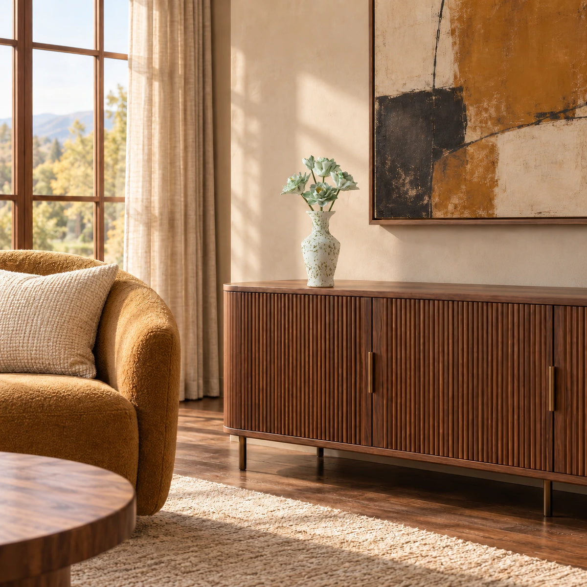 Five green-and-white ceramic flowers in a speckled cream vase on a fluted walnut sideboard with an ochre armchair, abstract art and a wool rug.