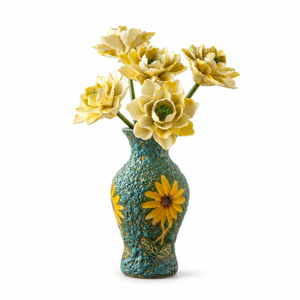 Five cream-yellow ceramic flowers in a textured turquoise vase with sunflower decoration on a white background.