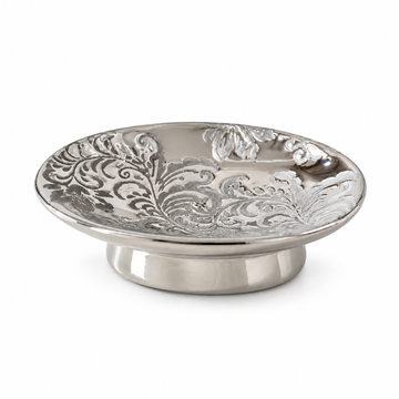Silver-toned round ceramic dish with an ornate floral pattern and a short pedestal base.