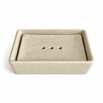 Warm cream speckled ceramic soap dish with a removable rectangular insert and three drainage holes.