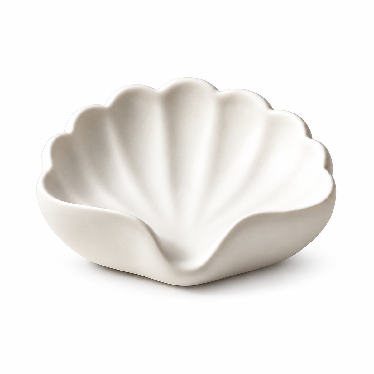Pearl white shell-shaped ceramic soap dish with radiating ridges and a scalloped edge.