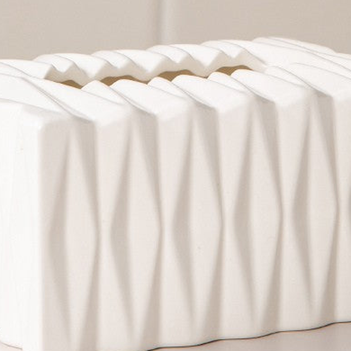 Original close view of white ceramic glaze, raised diamond facets and zigzag tissue opening.