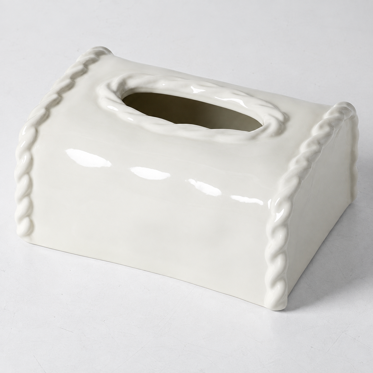 Close view of the white ceramic cover showing the raised oval rim and sculpted side borders.