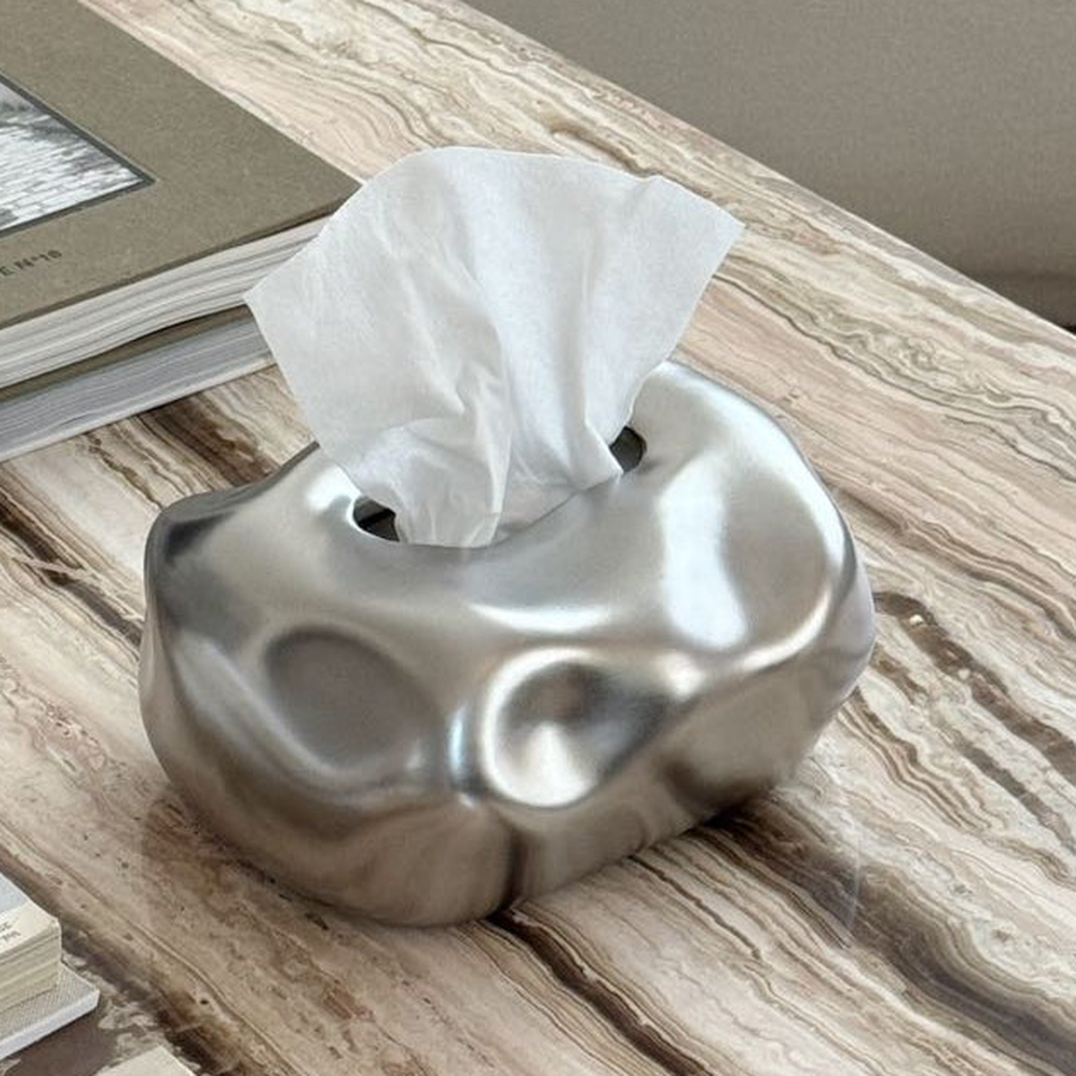Original close view of the silver ceramic bubble surface and top tissue opening.