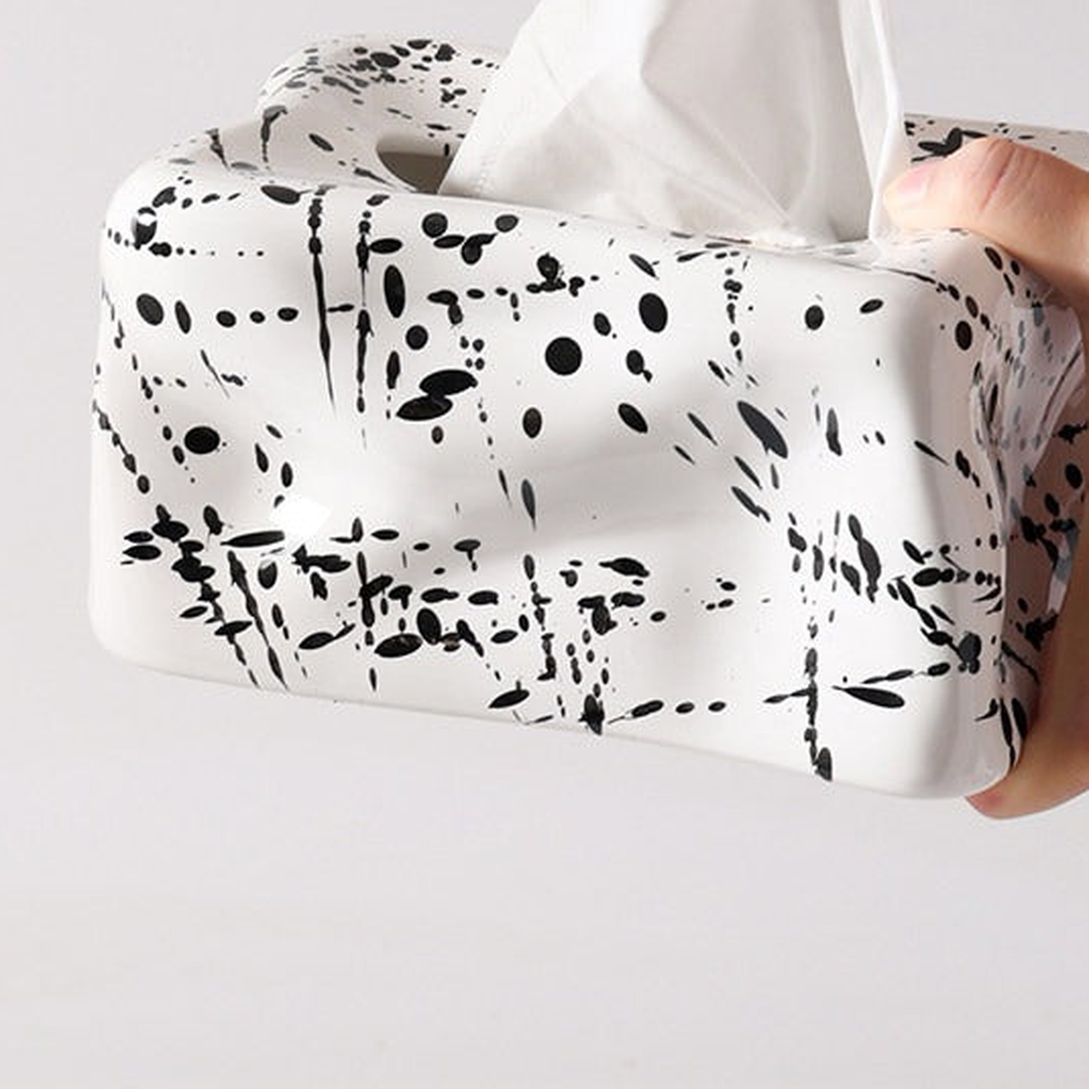 Original close view of Ink White ceramic with black flecks, wavy front and one tissue opening.