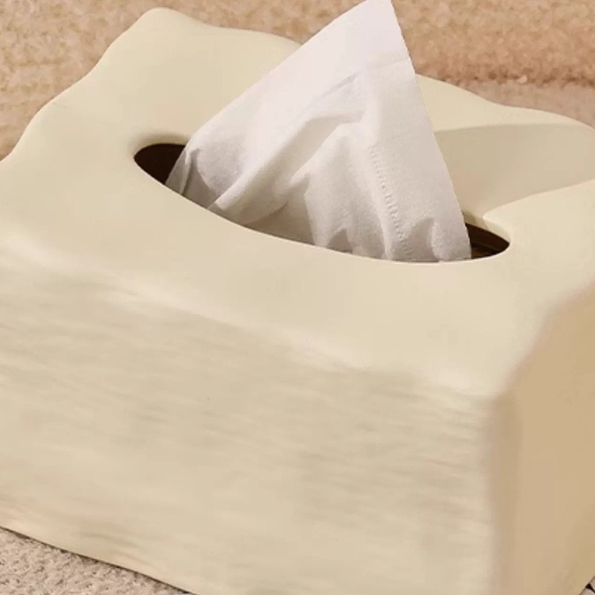 Close view of the Matte Butter Cream tissue cover’s top opening and fine horizontal ceramic texture.