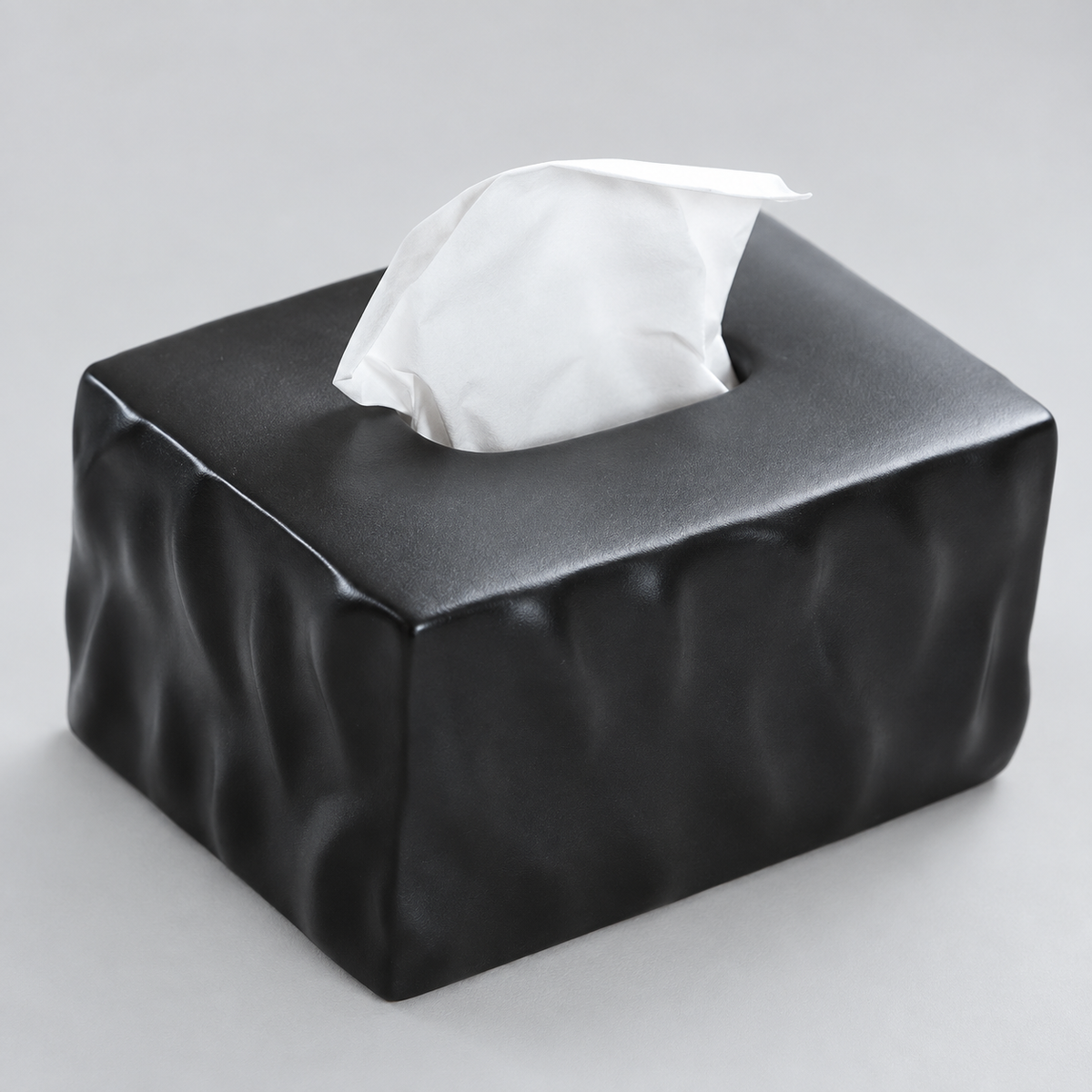 Close view of the Matte Noir tissue box cover showing irregular ceramic folds and the top opening.