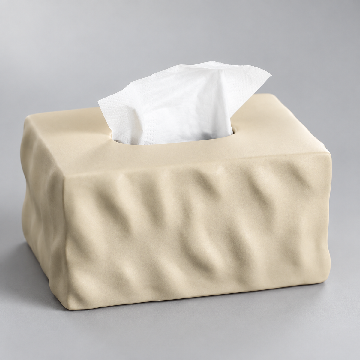 Close view of the Soft Mocha tissue box cover showing light beige ceramic folds and its top opening.