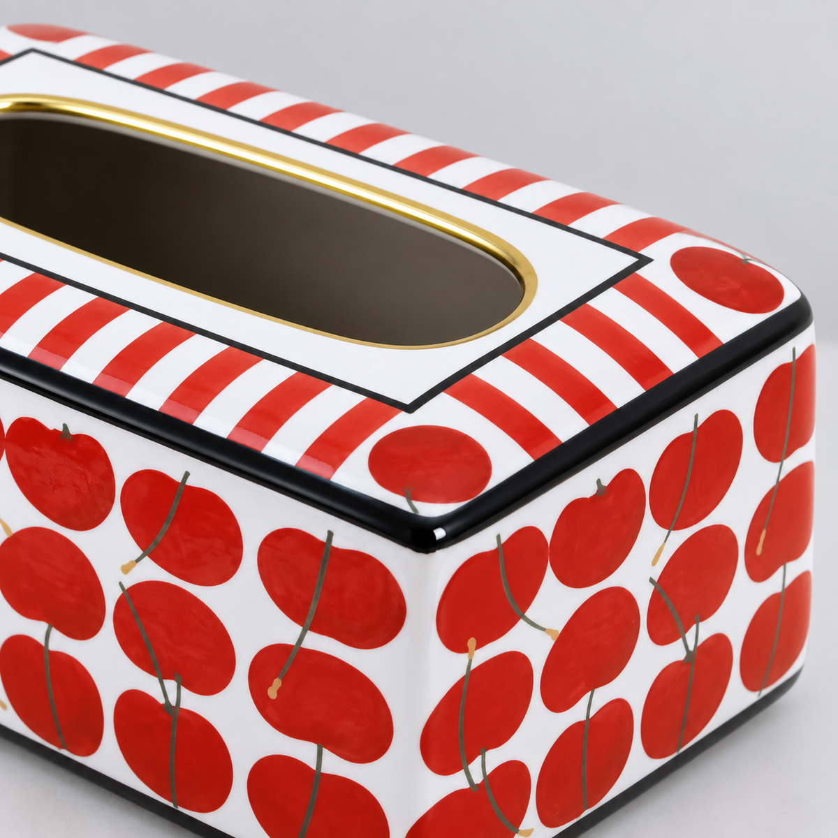 Close view of the striped top, gold-coloured slot rim and red cherry print at the corner