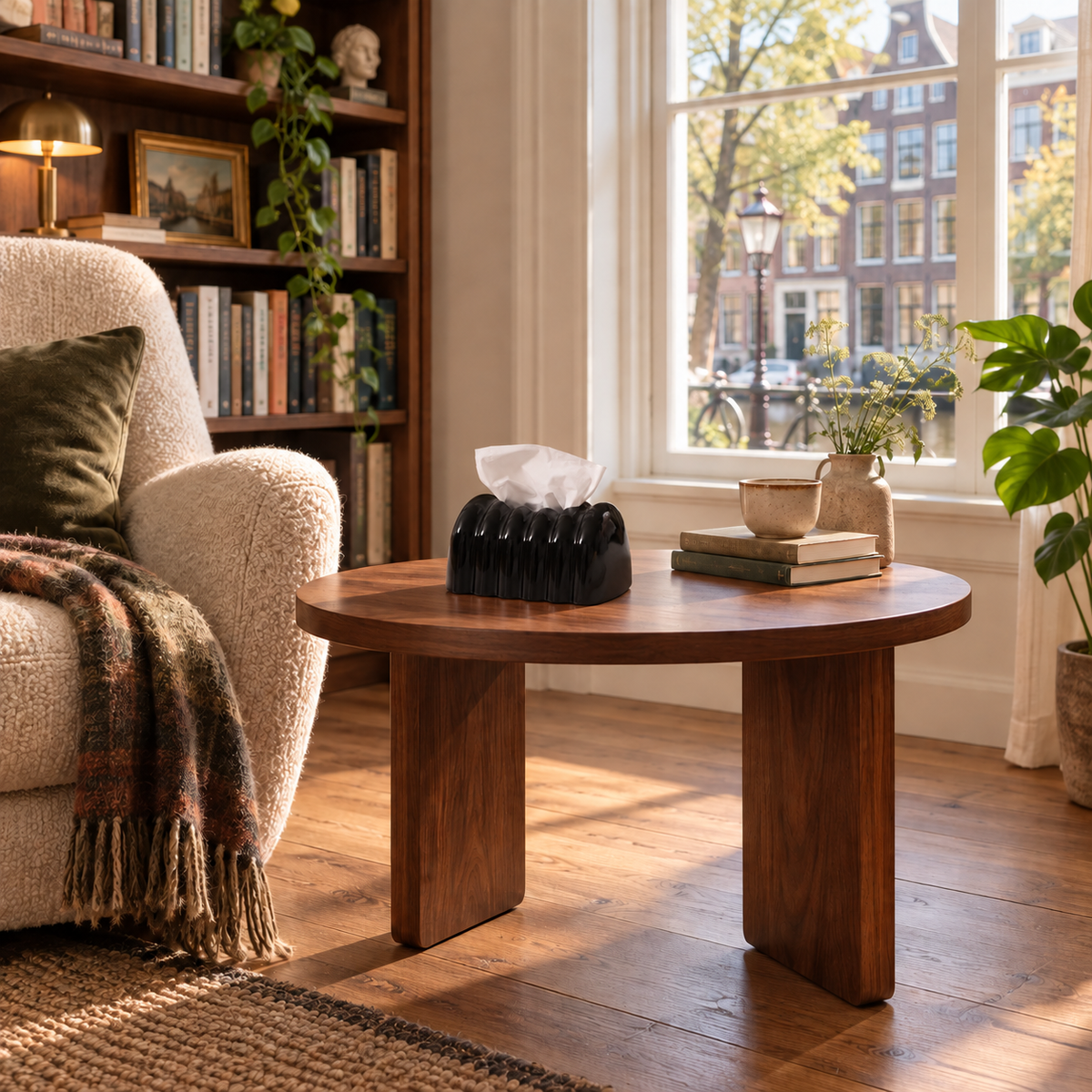 Polished Obsidian tissue cover on a walnut reading-room side table by an upholstered chair.